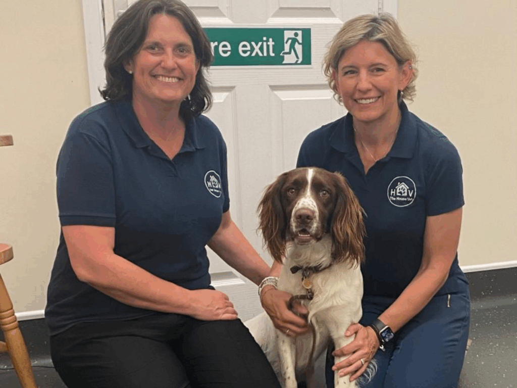 Alyson and Charlotte pose at Rowley House Vets with a police dog in training