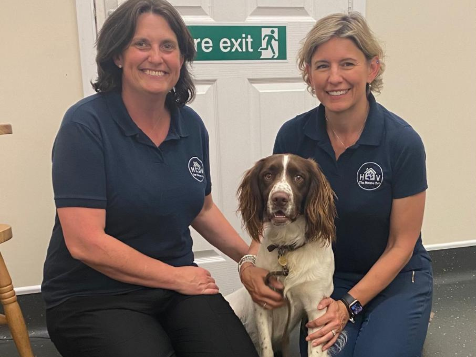Alyson and Charlotte pose at Rowley House Vets with a police dog in training