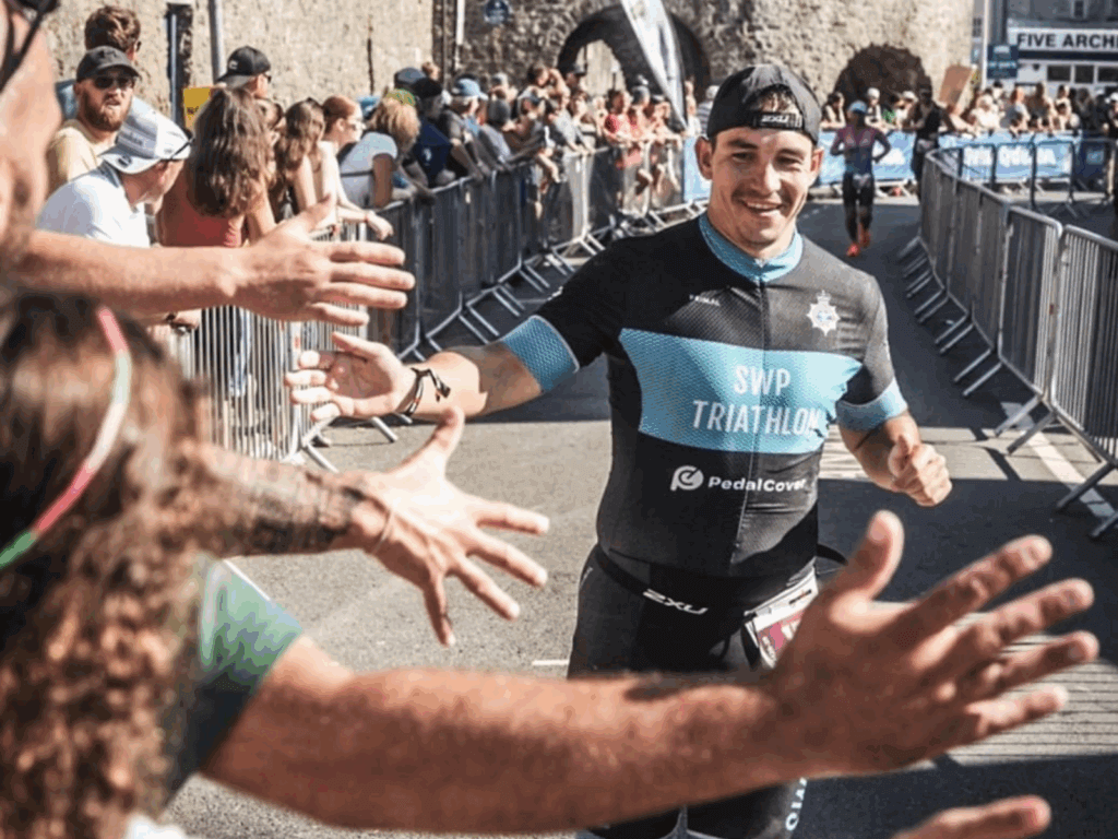 Jamie gives the crowd high fives as he runs past