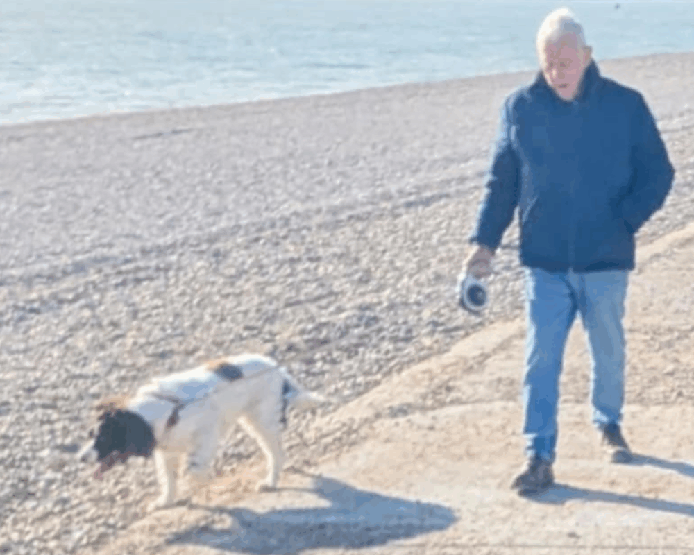 John walking Red along the beach