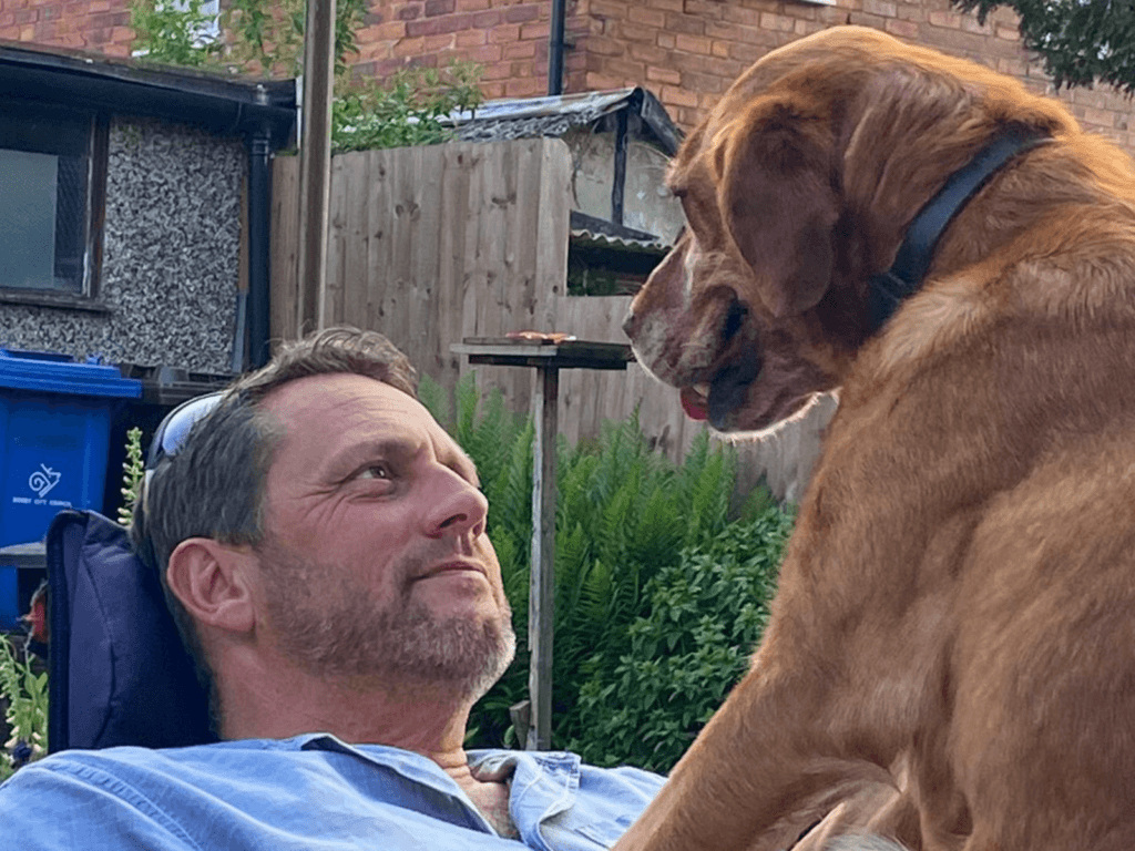 Retired police dog Tilly with her owner, Andrew